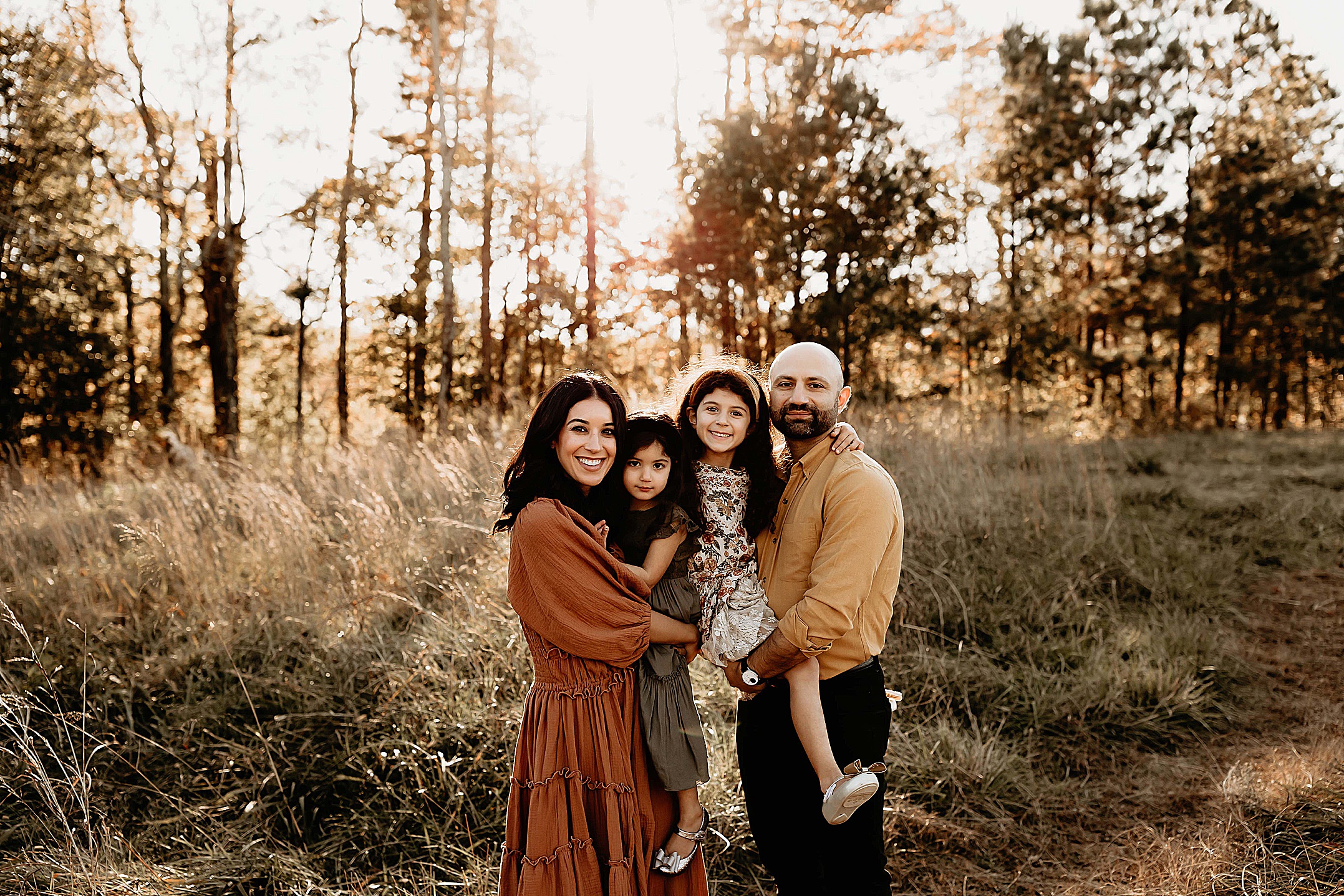 Family of 4 posing for fall family photos in Marietta, Ga.