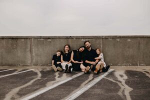 Family posing in Marietta square for photos.