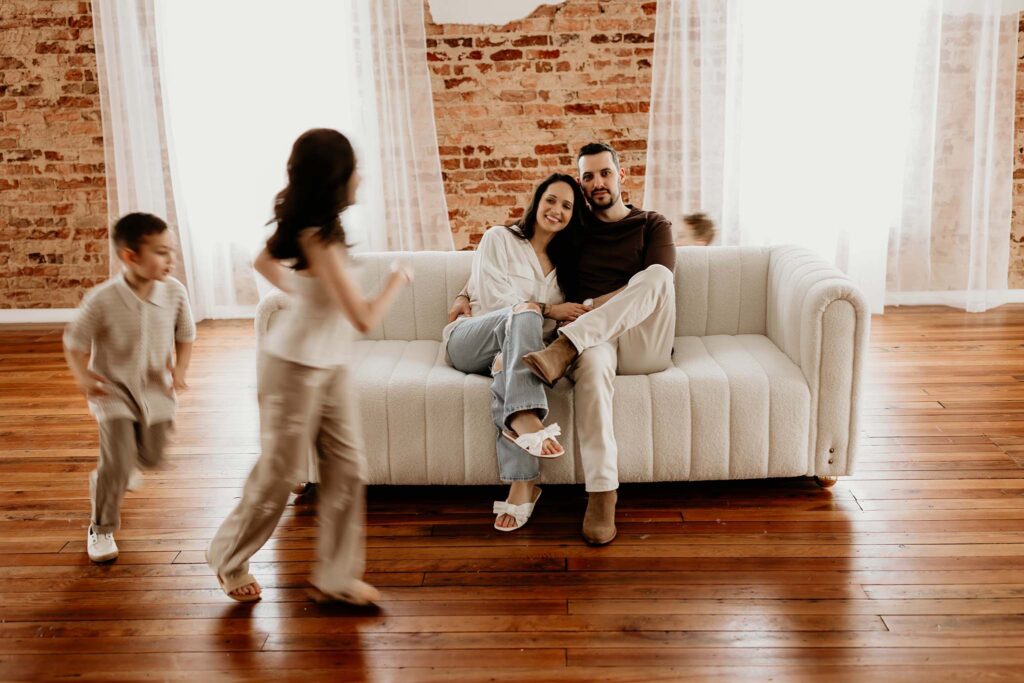 family sitting in a studio for family photos