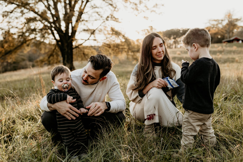 mom giving her son a snack at a family photo session